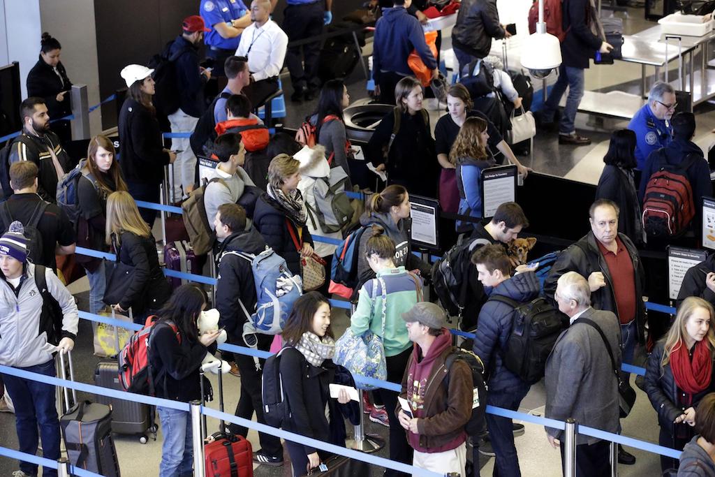 In this Sunday, Nov. 29, 2015, file photo, travelers line up at a security checkpoint area in Terminal 3 at O'Hare International Airport in Chicago. 