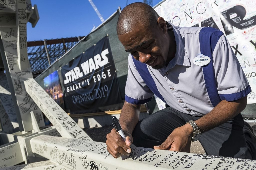A Walt Disney employee signs a steel beam that will be the highest point in Star Wars: Galaxy's Edge, the new land at Disney's Hollywood Studios. The land opens in late 2019.
