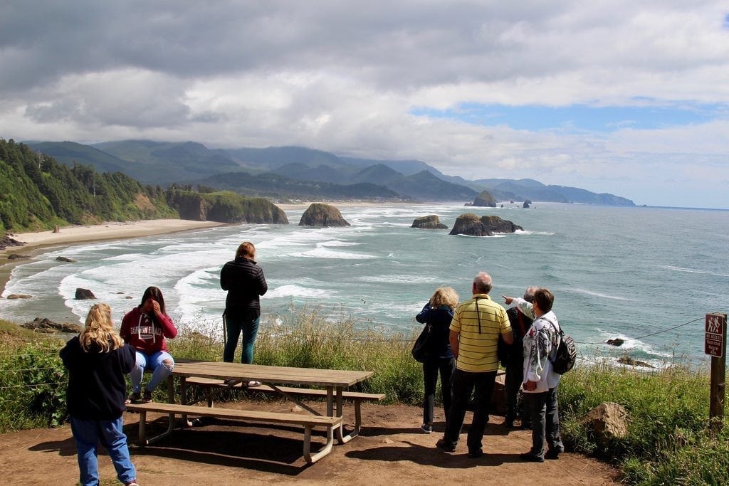 Oregon saw the largest increase in its state tourism marketing this year. Pictured are tourists at Ecola Point Overlook in Oregon's Ecola State Park.