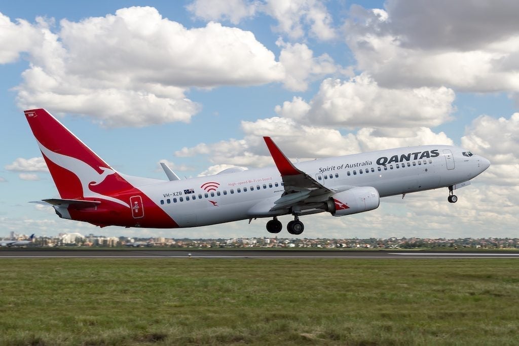 A Qantas aircraft taking off in a promotional image.