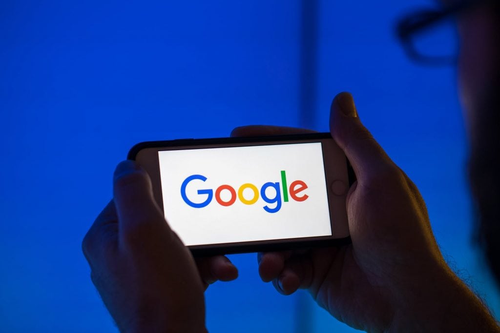 Google's logo is shown on a smartphone. The search giant gives preference to its own travel business, but claims of political bias are unfounded.