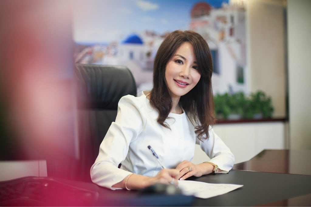 Ctrip CEO Jane Sun is shown here working in her office in Shanghai. Her company reported second-quarter earnings for 2018 on Wednesday.