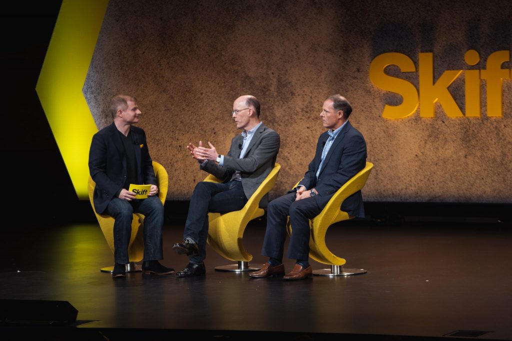 Google's Rob Torres and Richard Holden, right and center, on stage at Skift Global Forum 2018.