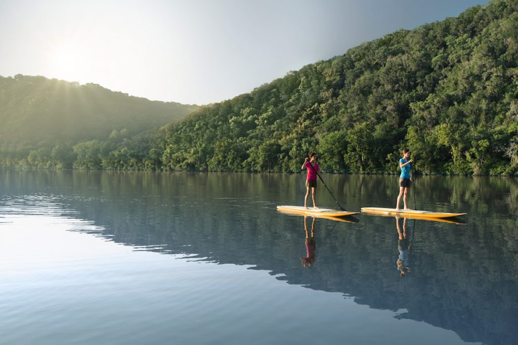 Paddle boarding at Lake Austin Spa Resort. The property is one of a number of wellness locations in the Austin, Texas area.