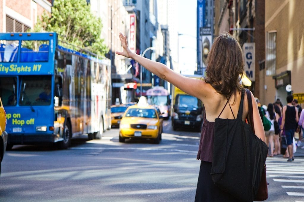 A woman hailing a cab in New York City.