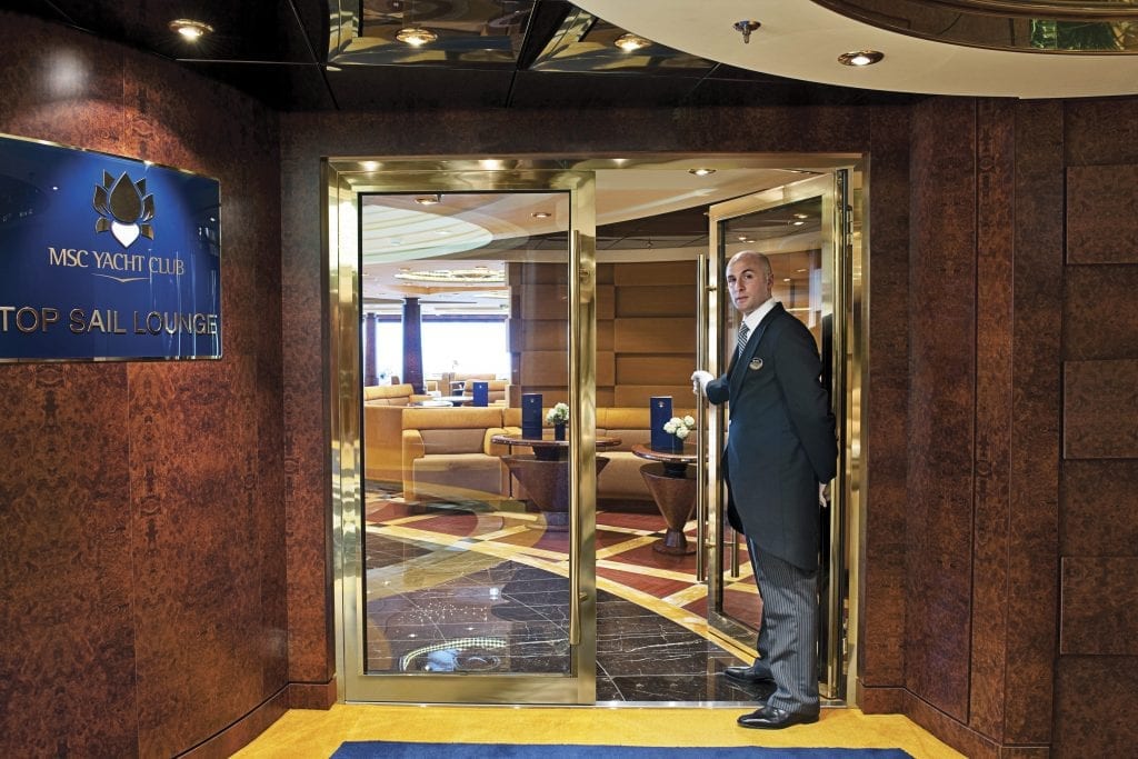 A butler is shown in the MSC Yacht Club, a small high-end enclave within a larger MSC Cruises ship. The privately held company is building four 