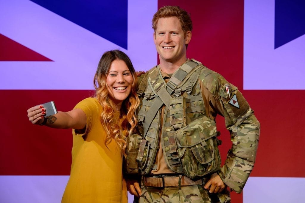 A guest meets a wax model of Prince Harry at Madame Tussauds London. Merlin Entertainments said it had seen a recovery in the London market.