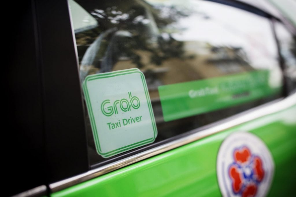 Pictured is a Grab taxi. The company entered into a strategic partnership with Booking Holdings.