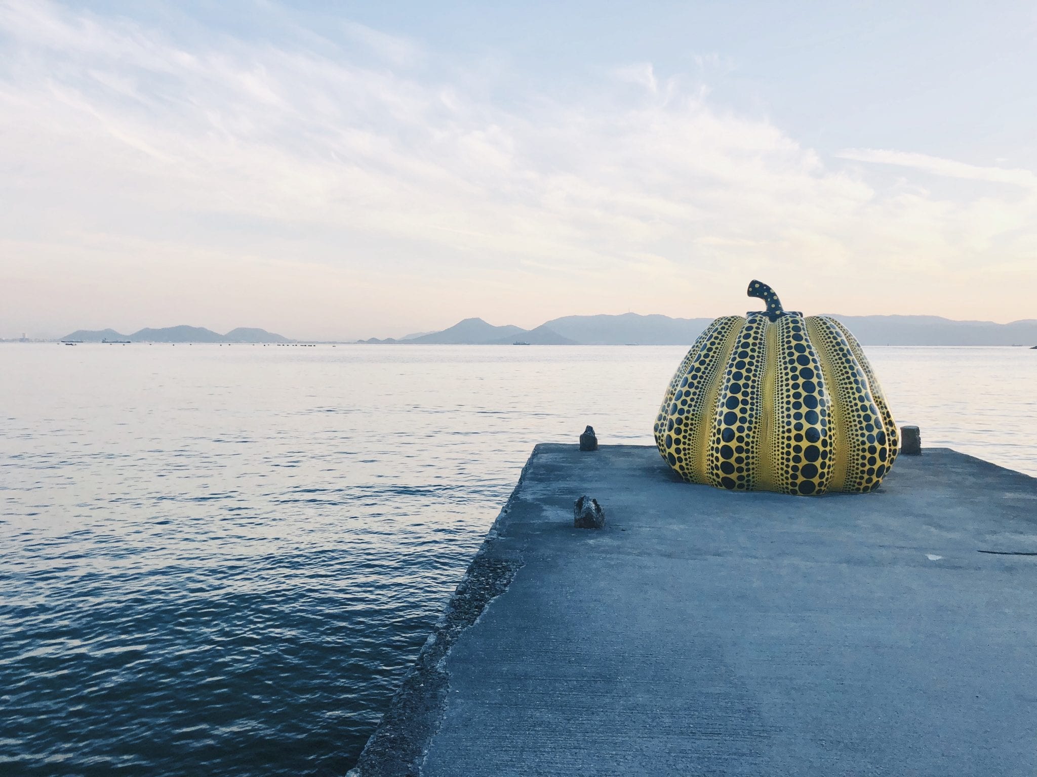 One of the most famous sculptures on Naoshima Island, Japanese artist Yayoi Kusama’s "Pumpkin," stands alone in twilight.