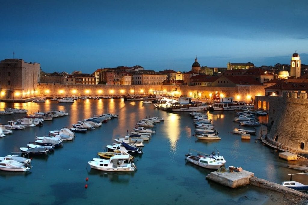 The old town harbor at night in Dubrovnik. Croatia is becoming a popular honeymoon spot.
