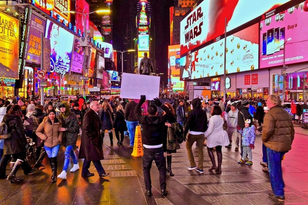 The U.S. Department of Commerce predicts a cheery outlook for international arrivals to the United States during the next five years. Pictured are tourists in Times Square in New York City.
