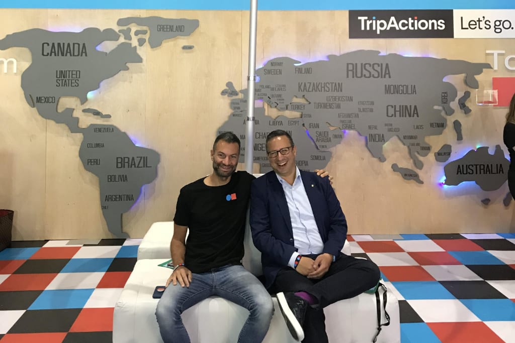 The co-founders of corporate travel agency TripActions shown are shown here at a company exhibition booth at Global Business Travel Association's main trade show in 2018, with CEO Ariel Cohen on the right and CTO Ilan Twig on the right.