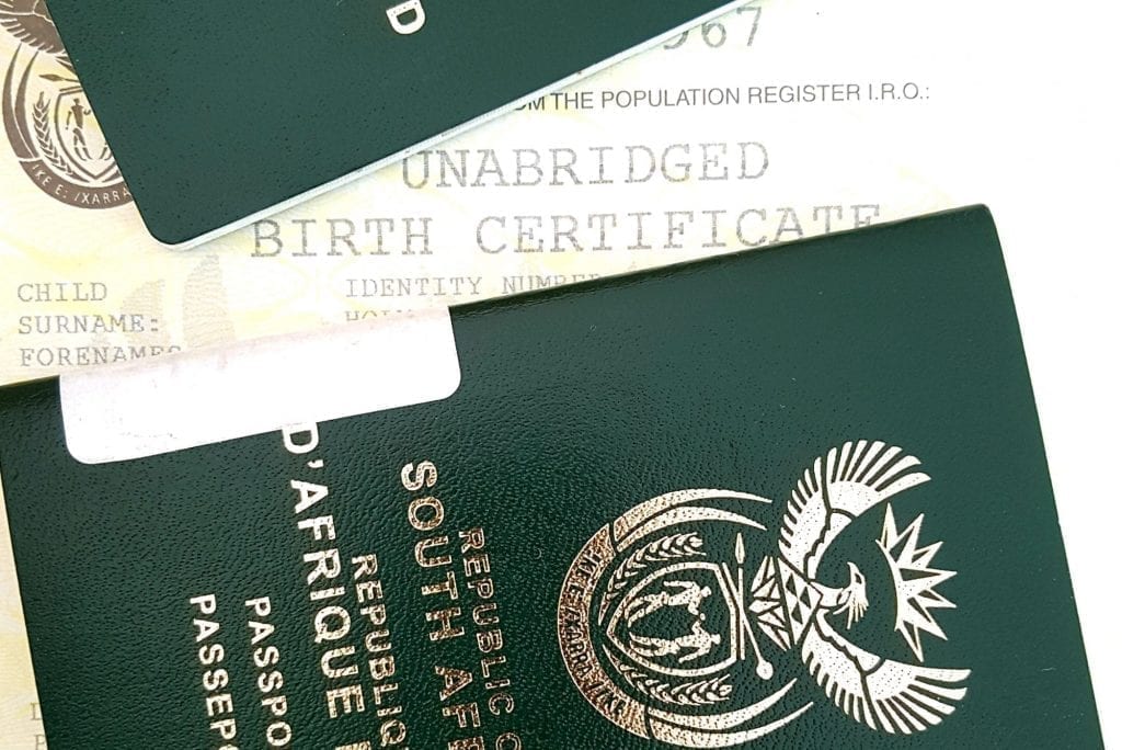 A South African passport and birth certificate are shown. The country has amended some visa regulations, but problems remain. 