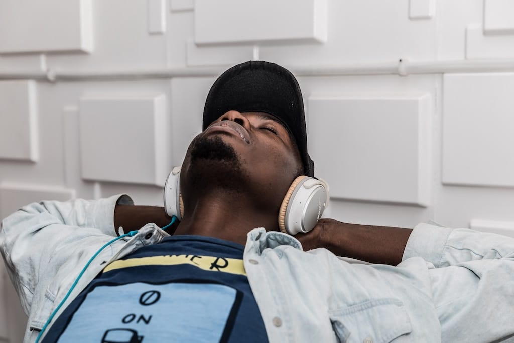A man is shown relaxing with headphones on. Meditation is now the fastest-growing wellness activity in the U.S., according to the CDC.