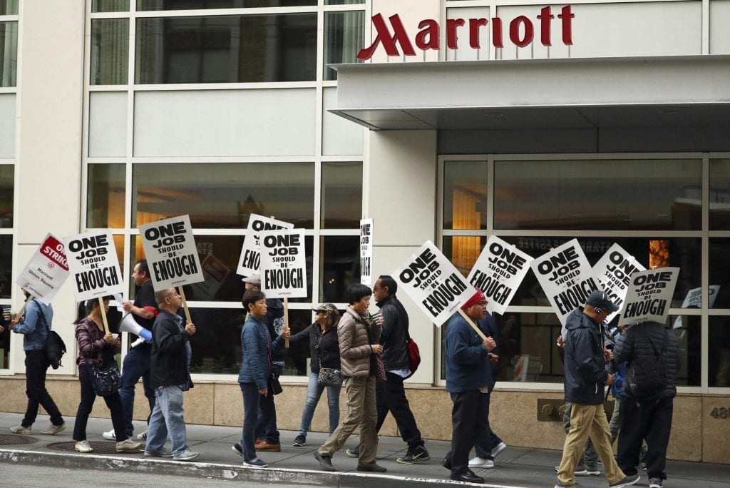 In this Oct. 4, 2018 file photo, hotel workers strike in front of a Marriott hotel in San Francisco. A contract agreement has been reached between Marriott and bargainers in San Francisco.