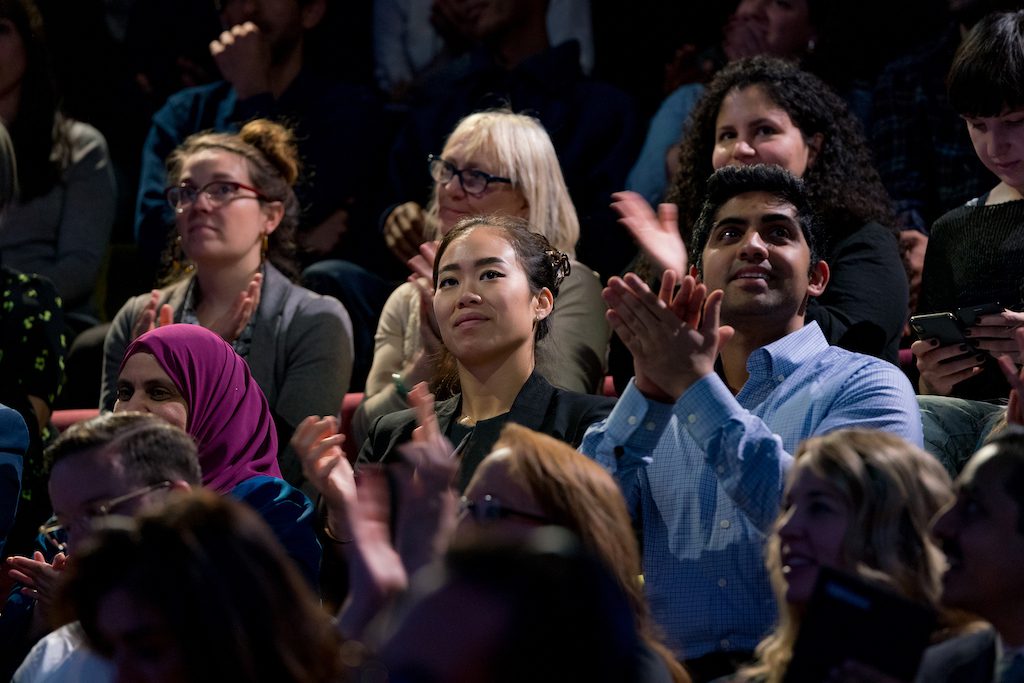 Attendees in the crowd at a TED event.