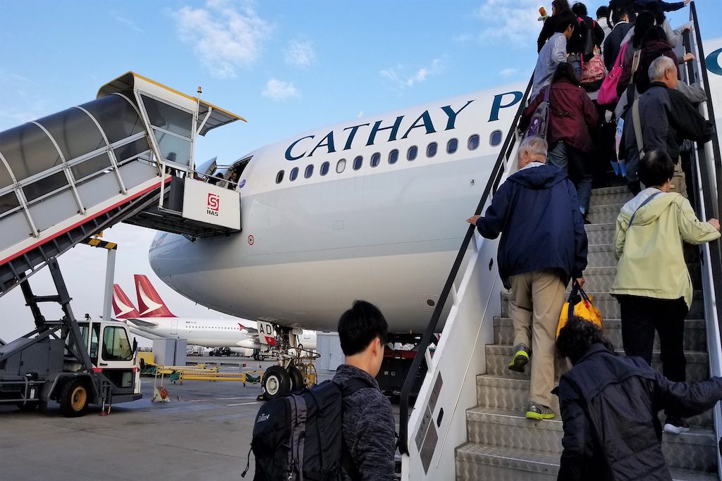 Passengers boarding a Cathay Pacific aircraft. Much of Asia's business travel is unmanaged in terms of strict company policies.