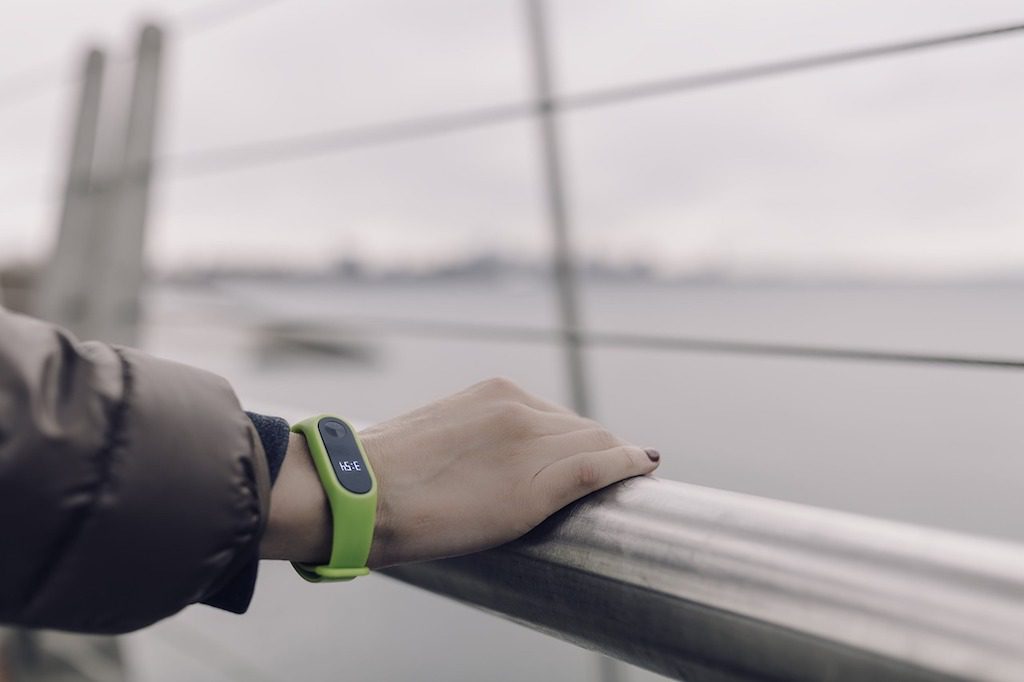 A woman is shown wearing a fitness tracker. Health and wellness tech products are making a splash at CES 2019.