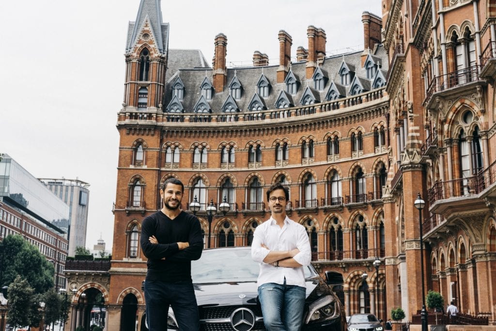 Virtuo, a car rental company, has raised $23 million in funding. Shown here is Virtuo’s co-founder, Karim Kaddoura (right) and co-founder Thibault Chassagne (left) with example cars for rent in front of the St. Pancras Renaissance Hotel in London. 