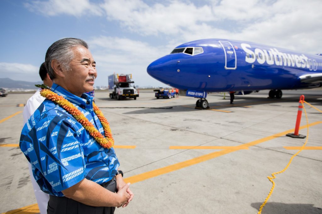 Hawaii Gov. David Ige greets the Southwest Airlines inaugural flight to Hawaii March 17, 2019 after it lands  in Daniel K. Inouye International Airport in Honolulu.