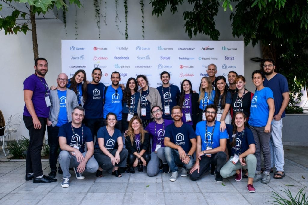 Several employees of Guesty, a vacation rental property management startup that has raised $35 million in Series C funding, gather for a team photo. Amiad Soto, co-founder and CEO of Guesty, is not present.