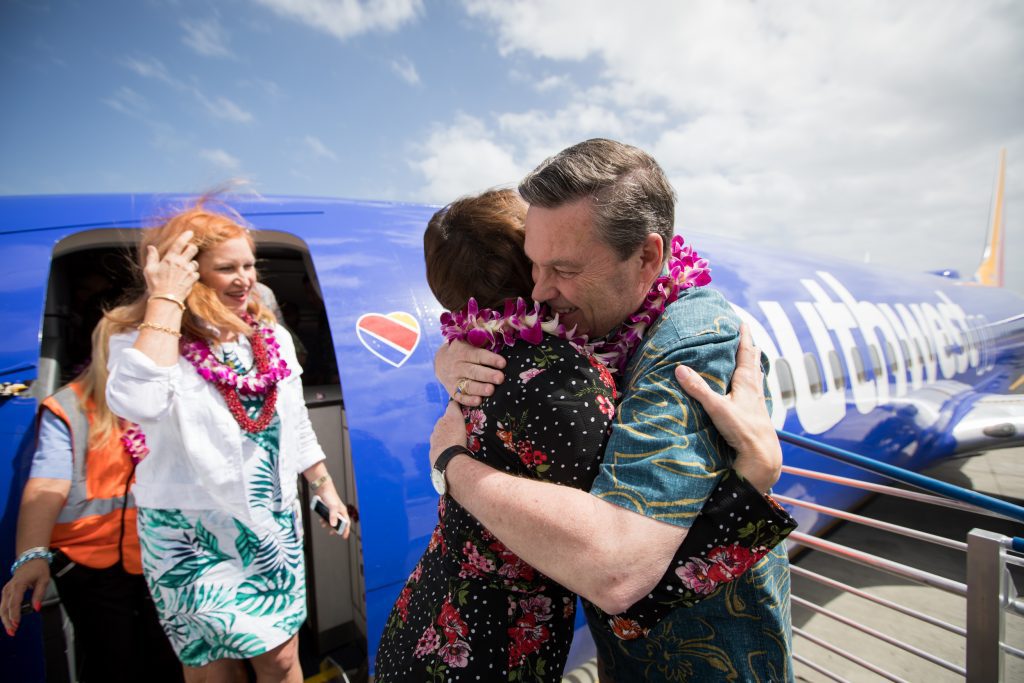 Southwest Airlines President Tom Nealon greets arriving passengers on the inaugural flight to Hawaii March 17, 2019 after it touches down in Daniel K. Inouye International Airport in Honolulu. 