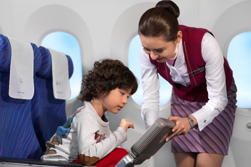 A China Southern flight attendant helps a passenger use the on-board entertainment system managed by TravelSky. TUI China has resumed selling domestic holidays.