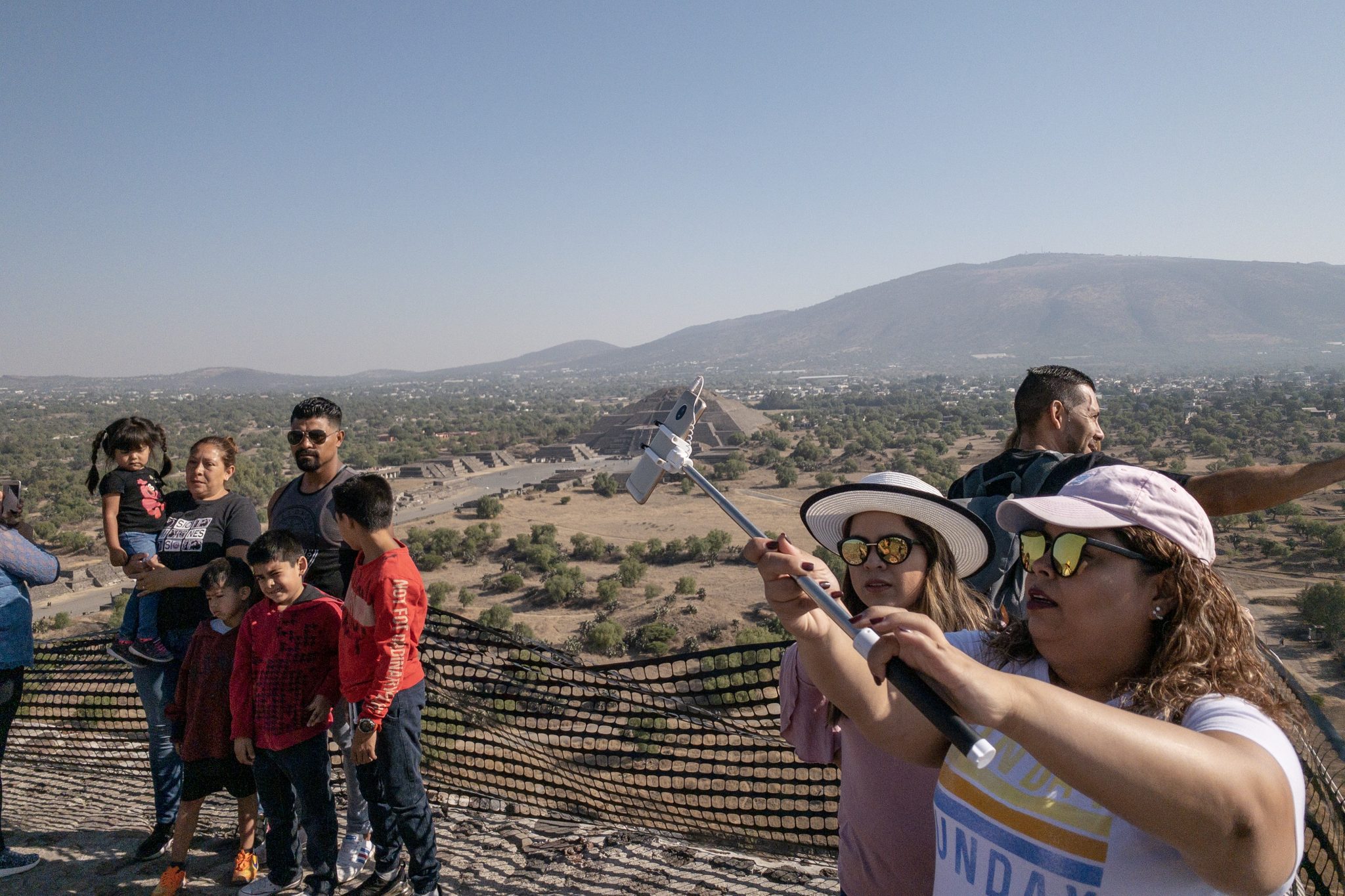 Tourists taking pictures atop the Pyramid of the Sun at the Teotihuacan site outside of Mexico City. 