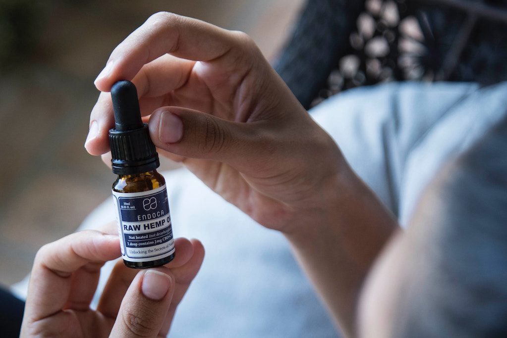 A bottle of hemp oil is shown. The wellness industry has clearly made its biggest inroads among women. That may partly be due to the shortcomings of the medical profession.