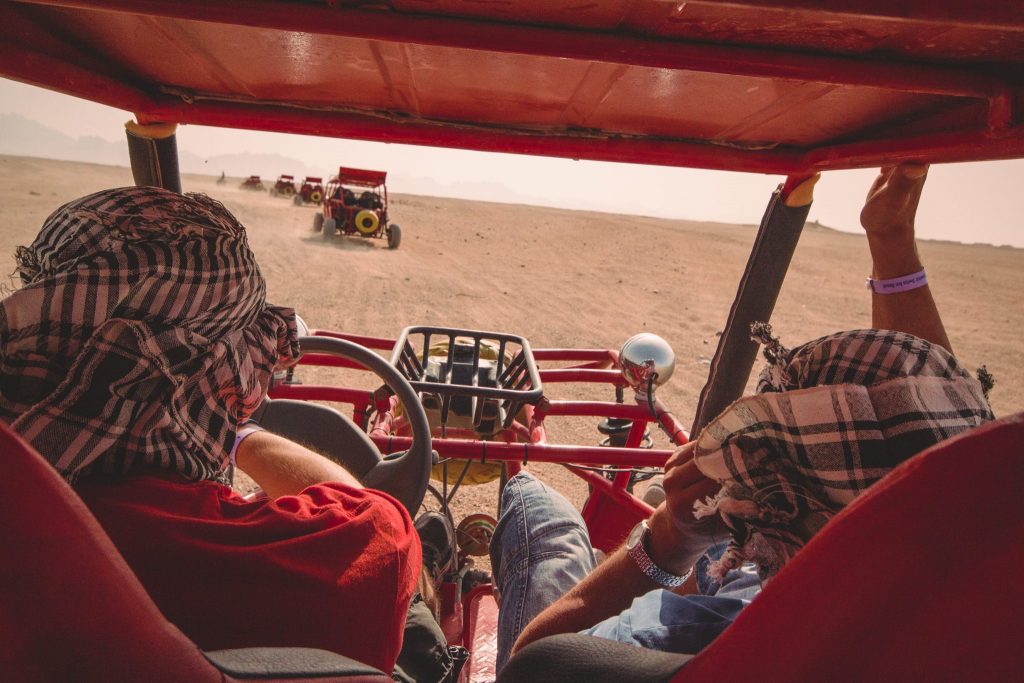Offers experiences like this dune buggy ride through the desert. 