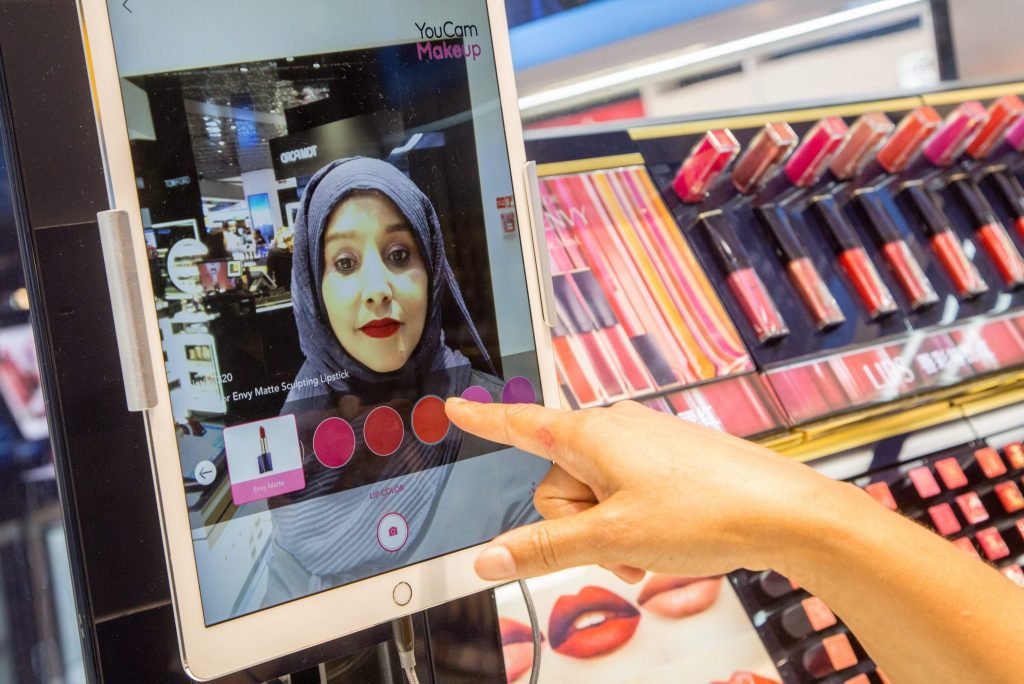 An interactive digital mirror for shade selection at Estee Lauder. High-end duty-free shopping is big business.