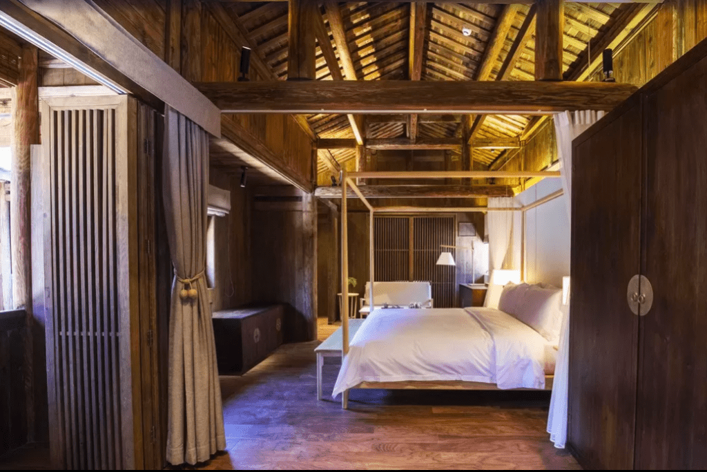 King-size bedroom at Tsingpu Tulou Retreat in the Fujian Province of southeastern China, a popular boutique hotel in Design Hotels portfolio.
