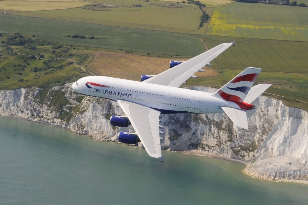 A British Airways A380 flying over the cliffs at Dover. BA parent company IAG is issuing new debt to raise $1.2 billion to buffer against the financial impact of the pandemic.