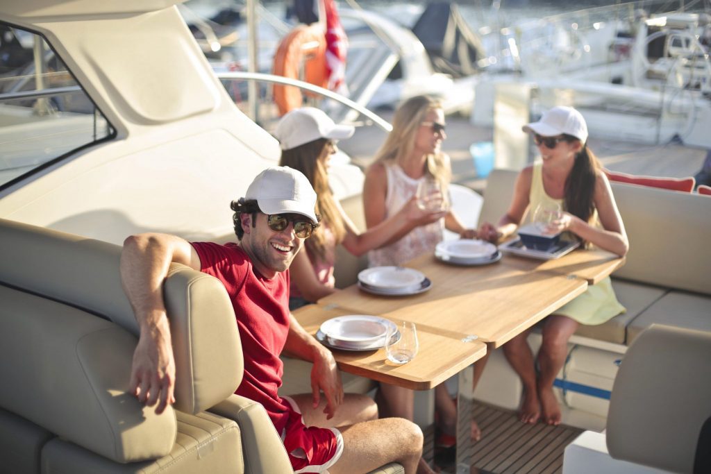 Although their incomes are all relatively high, U.S. affluent travelers have varying travel preferences. Above, four people enjoy time on a yacht.