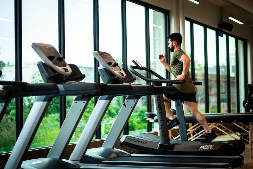  A man is shown running on a treadmill. Upscale gym brand Life Time plans to launch Life Time Living residences in 2020.