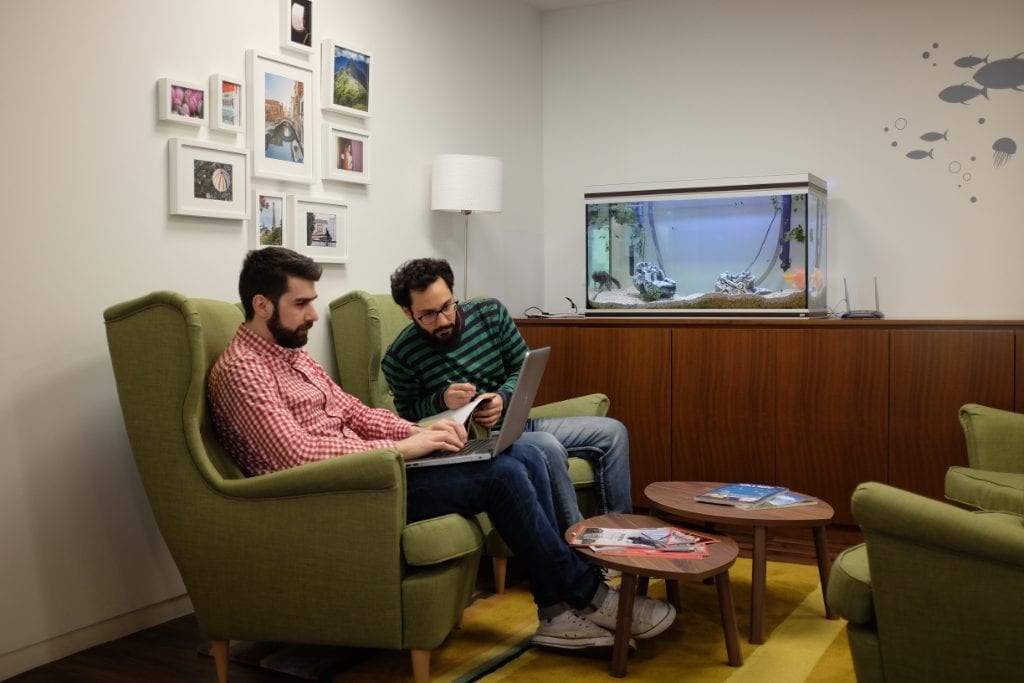 Some developers at work in the Athens, Greece, office of Etraveli, an online travel group based in Sweden. Hopefully they take better care of the software code than the fish in that fish tank.