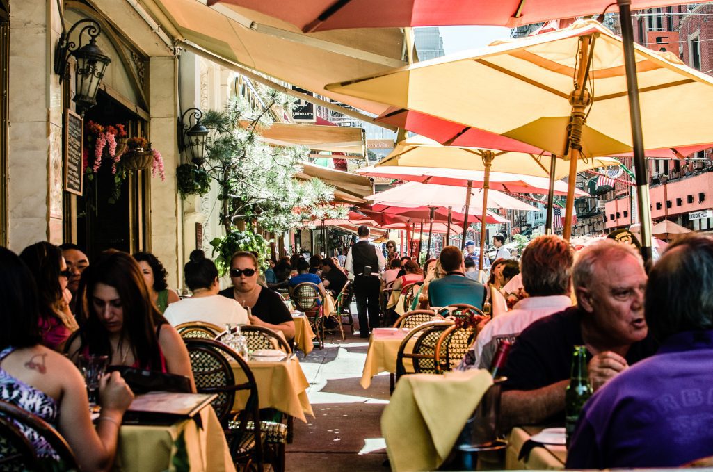 A fifth of Americans' total travel spending goes toward dining out, as at this restaurant in New York City's Little Italy.