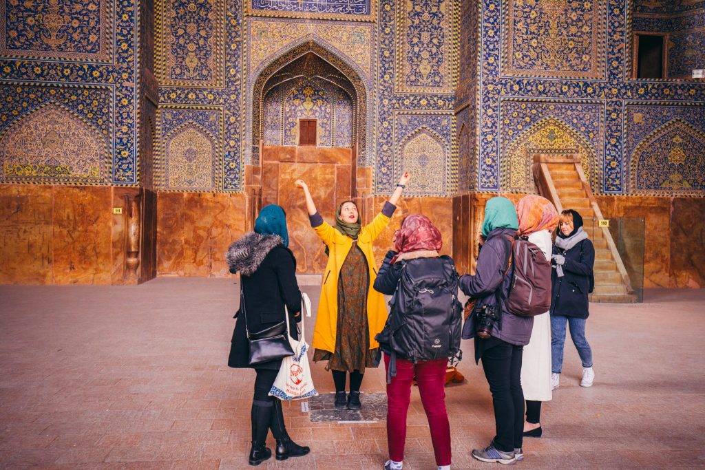Shown are tourists at the Shah Mosque in Isfahan, Iran. Iran is seeing increased tourism demand.