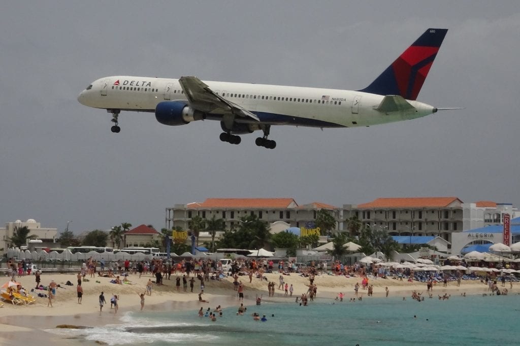 A Delta aircraft above a beach. The company enjoyed a good quarter.