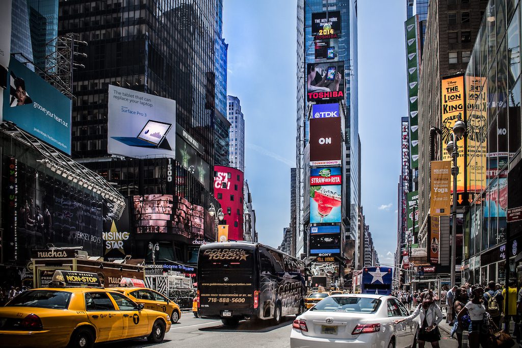 A street view of Times Square in New York City, a prominent tourist attraction for travelers.