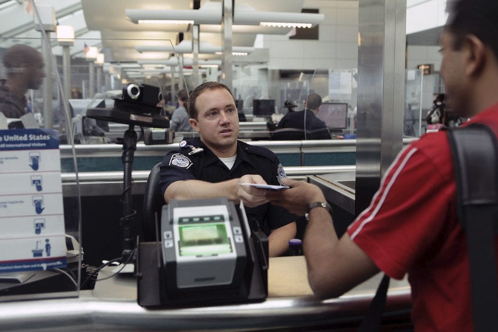 A CBP Officer processes an incoming passenger at the Newark International Airport. 
