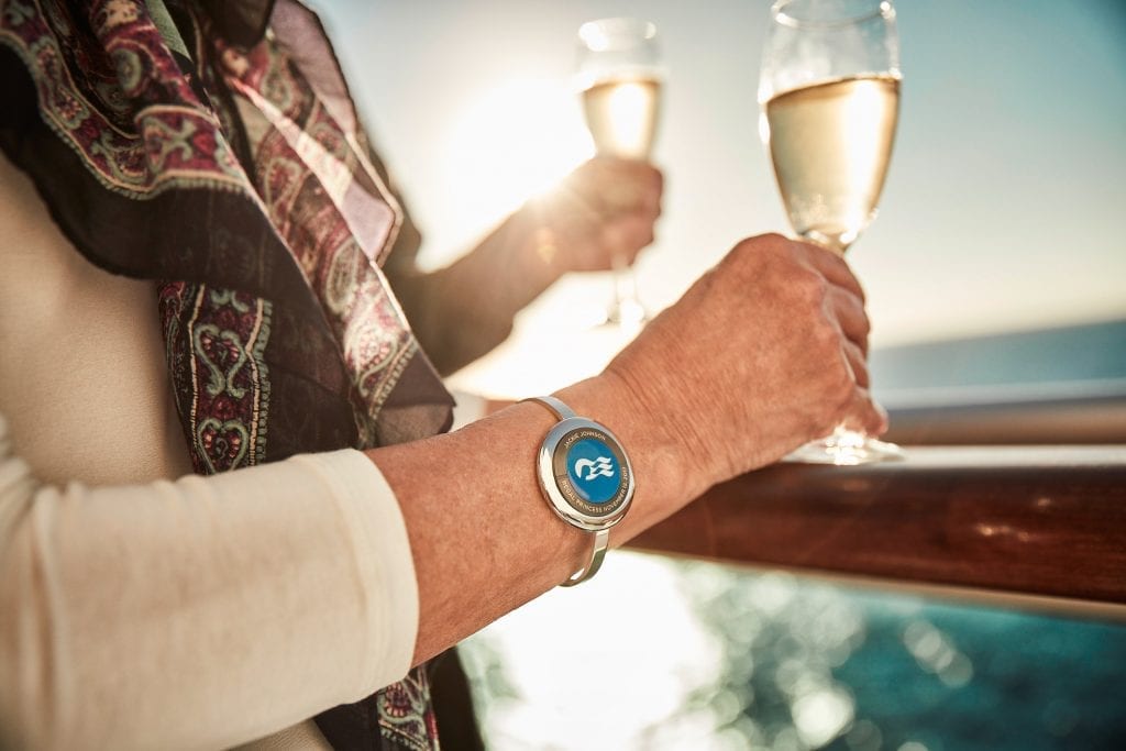 A guest wears a Carnival Corp. Ocean Medallion wristband. Travel advisors and their customers have to grapple with a bevy of cruise fees that are added to the fare.