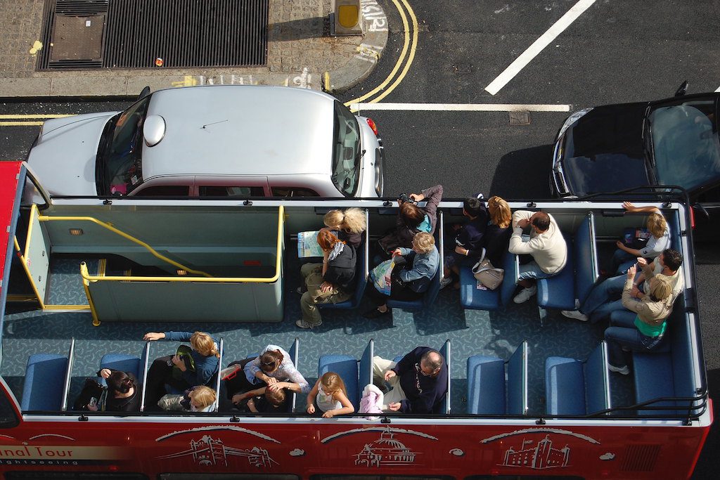 Tourists on a sightseeing bus.