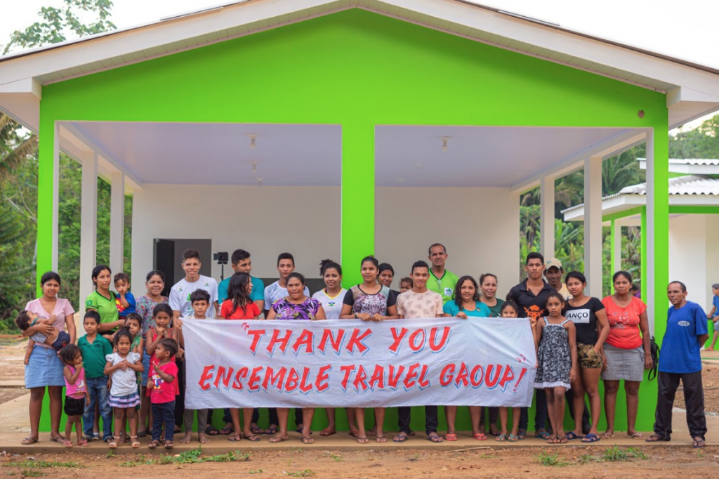 Participants in the Jacunda Forest Preserve in Brazil, a sustainability project to protect the rainforest and support local communities, thank Ensemble Travel for a donation made through Cool Effect. 