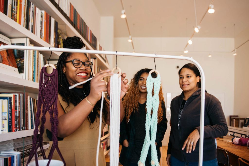 Airbnb host Kenyatta Forbes holds a Macrame workshop at the Bing Reading Room in Chicago, Illinois, on April 11, 2017. Expedia, Booking.com, and Ctrip are struggling to gain traction in the selling of sightseeing and experiences compared with new players like Airbnb.