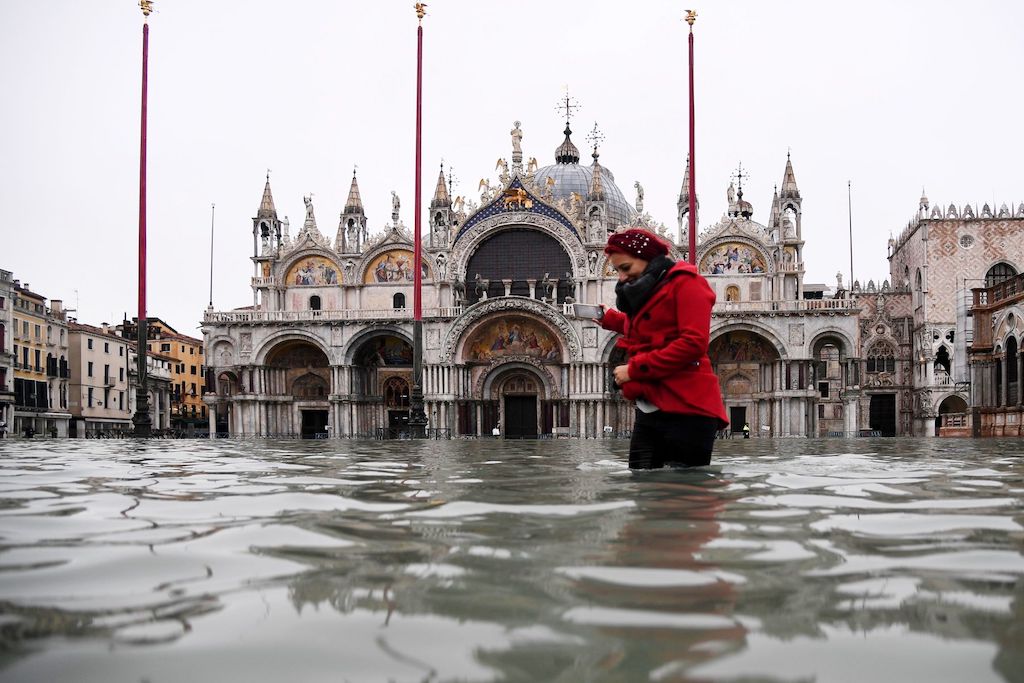 A woman wades through flood waters near St. Mark's Basilica in Venice, on Nov. 13.