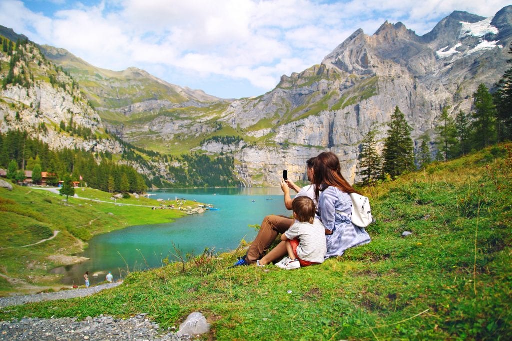 A family enjoys Lake Oeschinensee in Switzerland. Sabbaticals are growing in popularity with high-end consumers. 