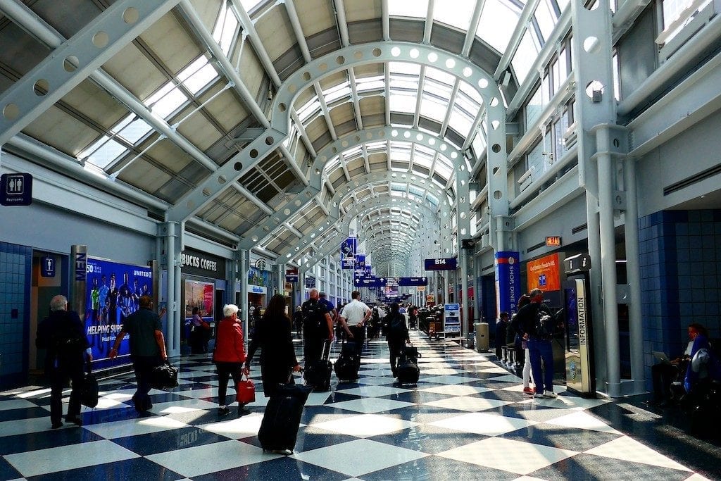 Travelers walk through a terminal at Chicago O'Hare International Airport.