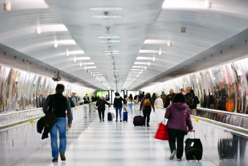 Passengers walking through Frankfurt International Airport. A leading German lawmaker is proposing to limit low prices on airline tickets. 