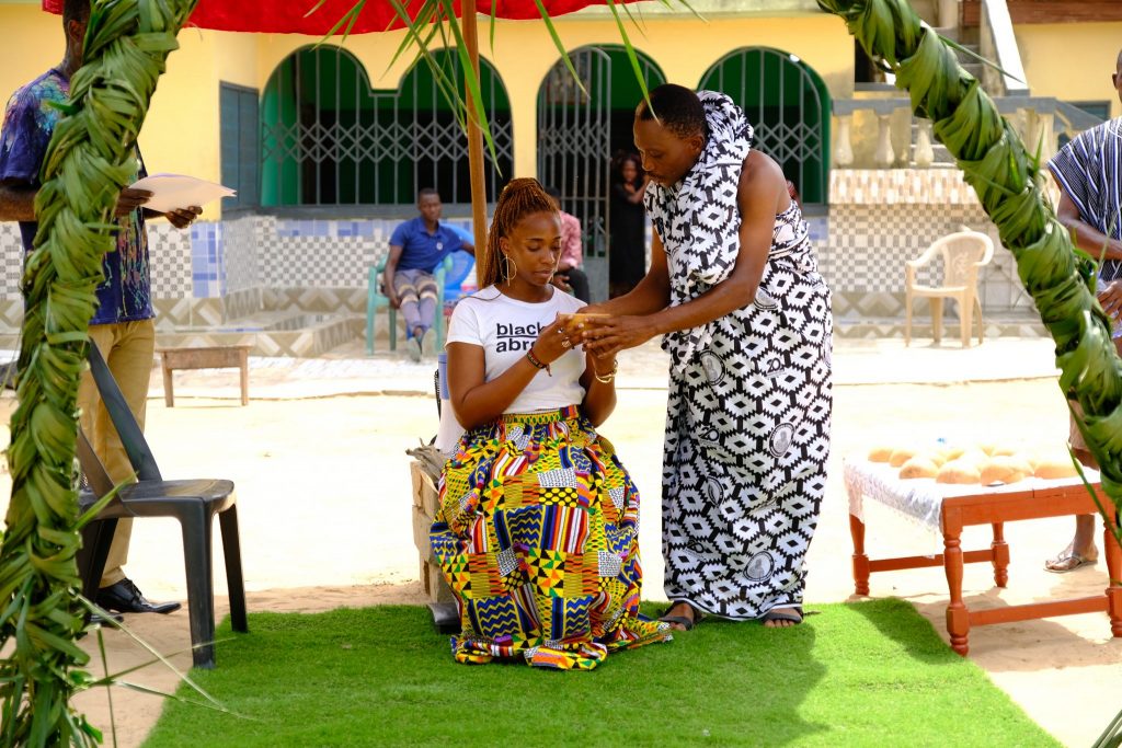 A traveler on a Black & Abroad trip to Ghana in Dec. 2019, at the end of the country's Year of Return, receives her Ghanaian name.